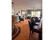 Living room with hardwood floors, ceiling fan, and view of lanai at 5557 Sea Forest Dr # 216, New Port Richey, FL 34652