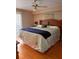 Comfortable main bedroom features a ceiling fan, closet, and a cozy bed with decorative pillows at 5557 Sea Forest Dr # 216, New Port Richey, FL 34652