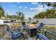 Inviting backyard fire pit with chairs, creating a cozy outdoor gathering space near the pool at 5805 S Hubert Ave, Tampa, FL 33616