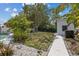 Beautiful backyard features a lush lawn, a modern outbuilding, mature trees, and a tranquil pool area, great for outdoor enjoyment at 5805 S Hubert Ave, Tampa, FL 33616
