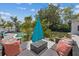 Stylish outdoor seating area with comfortable lounge furniture, perfect for enjoying the beautiful backyard and pool views at 5805 S Hubert Ave, Tampa, FL 33616