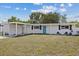 Lovely one-story home with a carport, well-maintained lawn, and charming curb appeal at 5805 S Hubert Ave, Tampa, FL 33616