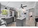 This bright kitchen boasts an island, stainless steel fridge, white countertops, and an adjacent breakfast nook at 5805 S Hubert Ave, Tampa, FL 33616