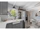 A spacious kitchen featuring gray cabinets, a farmhouse sink, and stainless steel refrigerator at 5805 S Hubert Ave, Tampa, FL 33616
