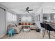 Inviting living room featuring a comfortable sofa, stylish decor, and a seamless transition to the kitchen at 5805 S Hubert Ave, Tampa, FL 33616