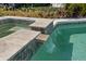 Stunning pool with stone accents and small waterfall feature into the pool at 5805 S Hubert Ave, Tampa, FL 33616