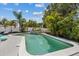 Beautiful pool featuring serene clear water and lush landscaping that creates a relaxing backyard oasis at 5805 S Hubert Ave, Tampa, FL 33616