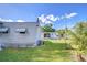 A single-story home with mature trees and a well-maintained lawn at 6044 Alpine Dr, Zephyrhills, FL 33542