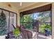 Screened balcony with seating and views of lush greenery at 612 Fairmont Ave # D, Safety Harbor, FL 34695
