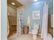 Well-lit bathroom with a tiled shower stall, toilet, and white curtain at 612 Fairmont Ave # D, Safety Harbor, FL 34695
