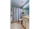 Well-lit bathroom features a sink, toilet and shower with a colorful curtain at 612 Fairmont Ave # D, Safety Harbor, FL 34695