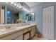 Bathroom featuring double sinks, ample counter space, vanity lighting and cabinet storage at 612 Fairmont Ave # D, Safety Harbor, FL 34695