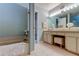 Bathroom featuring a bathtub and vanity with neutral countertops and stylish fixtures at 612 Fairmont Ave # D, Safety Harbor, FL 34695