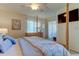 Bright bedroom featuring a four-poster bed, neutral walls, and access to an enclosed outdoor seating area at 612 Fairmont Ave # D, Safety Harbor, FL 34695