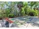 Community bocce ball court with bench seating surrounded by trees at 612 Fairmont Ave # D, Safety Harbor, FL 34695