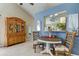 Cozy dining area with stylish chairs, neutral colors, and a passthrough window, creating a welcoming space at 612 Fairmont Ave # D, Safety Harbor, FL 34695