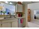 Kitchen sink and dishwasher area with view into living area, with stainless steel appliances at 612 Fairmont Ave # D, Safety Harbor, FL 34695