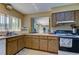 Functional kitchen featuring wooden cabinets and standard appliances at 612 Fairmont Ave # D, Safety Harbor, FL 34695