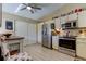 Kitchen with stainless steel appliances, modern cabinets, and a cozy dining area at 612 Fairmont Ave # D, Safety Harbor, FL 34695
