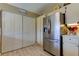 Bright kitchen with stainless steel refrigerator and large pantry closet at 612 Fairmont Ave # D, Safety Harbor, FL 34695