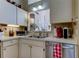 Well-lit kitchen with stainless steel appliances, double sinks, and ample counter space at 612 Fairmont Ave # D, Safety Harbor, FL 34695
