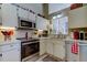 Bright kitchen featuring stainless steel appliances, lots of counter space, and modern fixtures at 612 Fairmont Ave # D, Safety Harbor, FL 34695