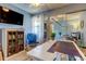Well-lit office with a large desk, blue glider rocker, TV, and decorative cabinet at 612 Fairmont Ave # D, Safety Harbor, FL 34695