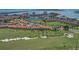 Beautiful aerial view of a golf course community, buildings with red tile roofs, and ocean views at 6191 Bahia Del Mar Blvd # 204, St Petersburg, FL 33715