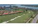 Scenic aerial shot showcases lush golf course, waterfront condos, and stunning bay views at 6191 Bahia Del Mar Blvd # 204, St Petersburg, FL 33715