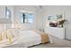 Cozy bedroom with white bedding, soft carpet, and natural light streaming through the window at 6191 Bahia Del Mar Blvd # 204, St Petersburg, FL 33715