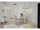 Bright dining area with white tiled floor and modern pendant lighting at 6191 Bahia Del Mar Blvd # 204, St Petersburg, FL 33715