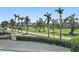 Scenic golf course view featuring palm trees, manicured landscaping, and a glimpse of the serene waterside at 6191 Bahia Del Mar Blvd # 204, St Petersburg, FL 33715