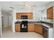 Well-equipped kitchen with tile floors and access to in-unit laundry at 6191 Bahia Del Mar Blvd # 204, St Petersburg, FL 33715