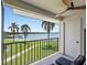 Relaxing balcony with seating area offering serene views of lush greenery and tranquil waterfront at 6361 Bahia Del Mar Blvd # 205, St Petersburg, FL 33715