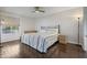 Well-lit bedroom with a large bed, dark floors, and neutral decor at 6361 Bahia Del Mar Blvd # 205, St Petersburg, FL 33715