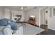 Open living room with a TV, modern furnishings, and a view to the kitchen at 6361 Bahia Del Mar Blvd # 205, St Petersburg, FL 33715
