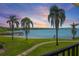 Beautiful water view with palm trees and a dock at sunset at 6361 Bahia Del Mar Blvd # 205, St Petersburg, FL 33715