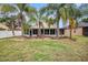 Spacious backyard with brick patio, fire pit, and screened-in porch at 6711 Thackston Dr, Riverview, FL 33578