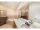 This bathroom features a double vanity, a soaking tub, and a tiled shower at 6711 Thackston Dr, Riverview, FL 33578