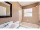 Bathroom with a sink, toilet, and a tiled shower/tub combination at 6711 Thackston Dr, Riverview, FL 33578