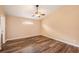 Bedroom featuring wood-look floors and ample natural light at 6711 Thackston Dr, Riverview, FL 33578