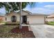 Charming single-story home featuring a two-car garage and a well-manicured front yard at 6711 Thackston Dr, Riverview, FL 33578