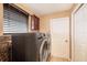 Functional laundry room featuring modern washer and dryer units and storage at 6711 Thackston Dr, Riverview, FL 33578