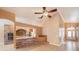 Open living room featuring tile floors, brick accents, and seamless flow to other living spaces at 6711 Thackston Dr, Riverview, FL 33578