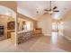 Open living room featuring tile floors, brick accents, and seamless flow to other living spaces at 6711 Thackston Dr, Riverview, FL 33578