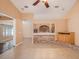 Open living room featuring tile floors, brick accents, and seamless flow to other living spaces at 6711 Thackston Dr, Riverview, FL 33578