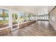 Screened porch with wood-look floors and views of the backyard at 6711 Thackston Dr, Riverview, FL 33578