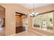 Bright sun room featuring French doors, brick accents, and wood-look tile flooring at 6711 Thackston Dr, Riverview, FL 33578