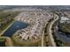 Birds eye view of homes in the community located on the water with landscaped lawns and street appeal at 10101 Mangrove Well Rd, Ruskin, FL 33573