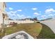 Expansive backyard with white fencing and patio furniture, perfect for entertaining guests at 10101 Mangrove Well Rd, Ruskin, FL 33573